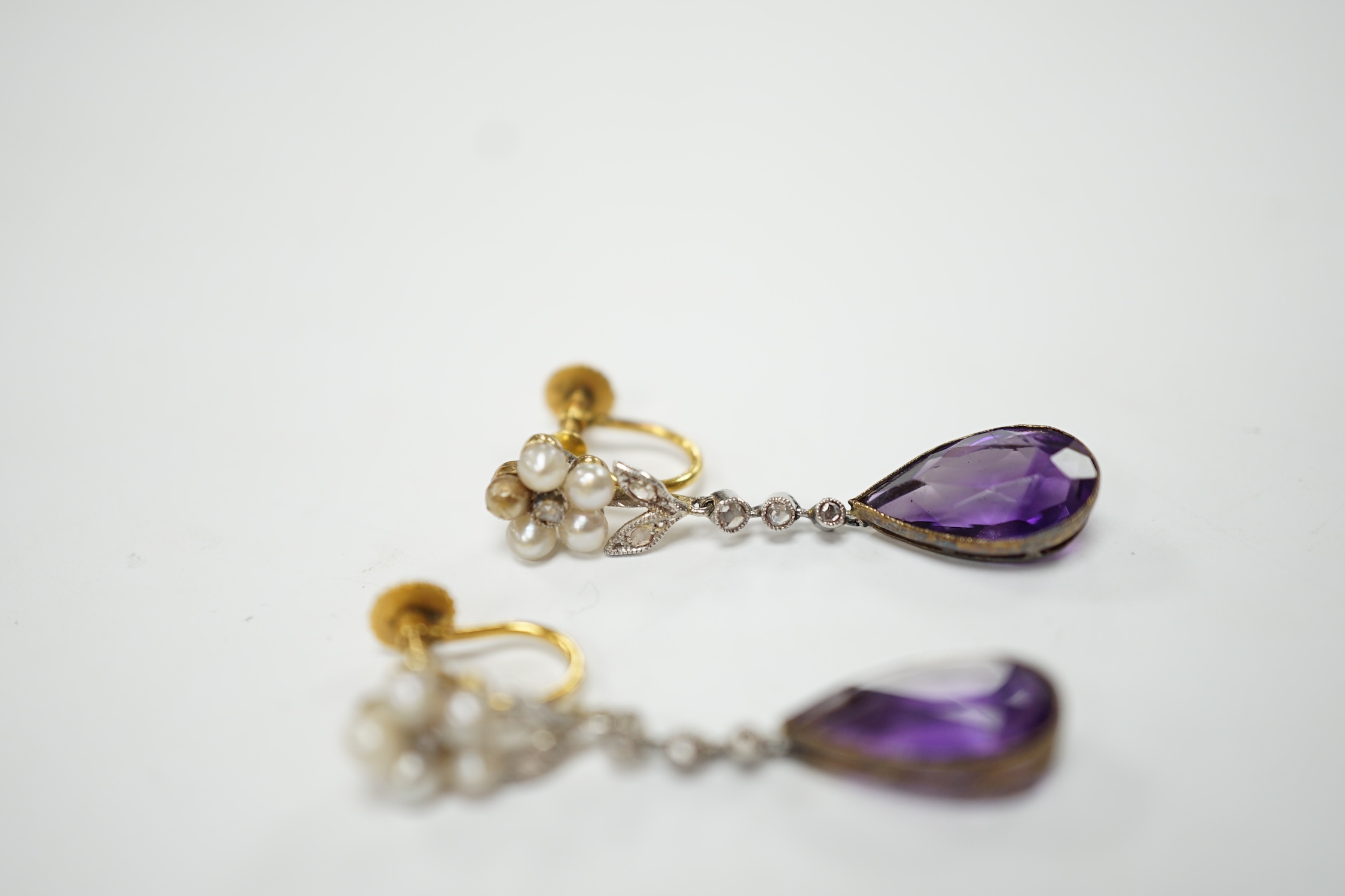 A pair of early to mid 20th century 9ct, amethyst, diamond and seed pearl set drop ear clips, 34mm, gross weight 4.7 grams. Fair to poor condition.